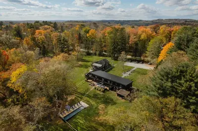 an aerial view of a house in the middle of a forest at Suite 001 in Kenoza Lake