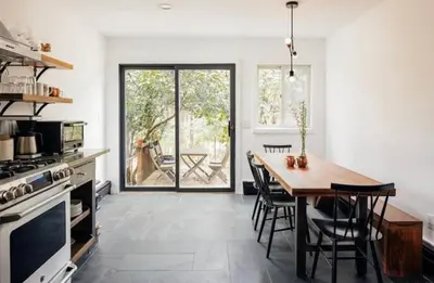 a kitchen with a wooden table and a dining room at Catskills ChestnutCreek+Swimming Hole+Firepit+Hike in Neversink