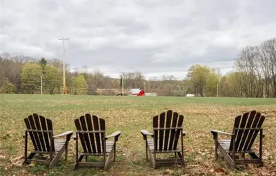 three adirondack chairs sitting in a field at Catskills ChestnutCreek+Swimming Hole+Firepit+Hike in Neversink