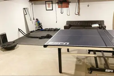 a ping pong table in a room with a couch at Catskills ChestnutCreek+Swimming Hole+Firepit+Hike in Neversink
