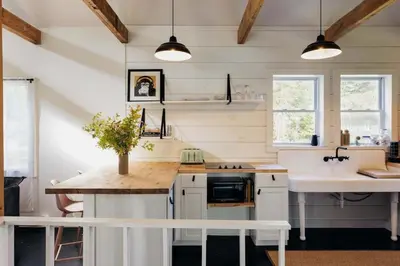 a kitchen with white cabinets and a counter top at FOUNDERS COTTAGE - 2 room with kitchennete in Kenoza Lake