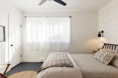 a bedroom with a bed with a ceiling fan at FOUNDERS COTTAGE - 2 room with kitchennete in Kenoza Lake