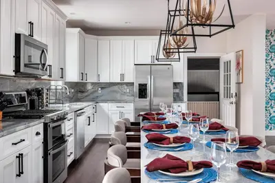 a kitchen with a table with red napkins on it at The Poconest - Luxurious Mountain Mansion in Long Pond