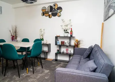 a living room with a blue couch and a table at Anike's Place in Newark