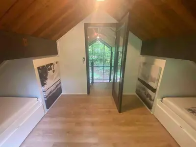 a room with a hallway with two beds and a mirror at Cozy Cottage 1 Block Walk From Lake Naomi - Poconos Pennsylvania Area 2 hours from New York City or Philadelphia - Pets Welcome - Check Minimum Night Requirement in Pocono Pines