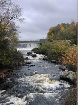a river with a waterfall in the background at Cozy Cottage 1 Block Walk From Lake Naomi - Poconos Pennsylvania Area 2 hours from New York City or Philadelphia - Pets Welcome - Check Minimum Night Requirement in Pocono Pines