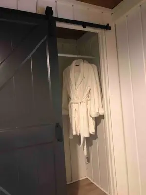 a robe hanging in a closet next to a door at Cozy Cottage 1 Block Walk From Lake Naomi - Poconos Pennsylvania Area 2 hours from New York City or Philadelphia - Pets Welcome - Check Minimum Night Requirement in Pocono Pines
