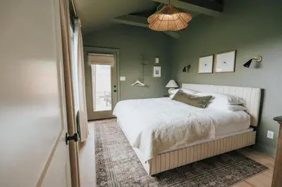 a bedroom with a white bed and green walls at Luxury Cabin at Beaver Creek with hot tub and stunning views in Strasburg