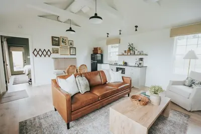 a living room with a couch and a table at Luxury Cabin at Beaver Creek with hot tub and stunning views in Strasburg