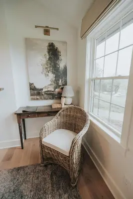 a wicker chair in a room with a desk and a window at Luxury Cabin at Beaver Creek with hot tub and stunning views in Strasburg