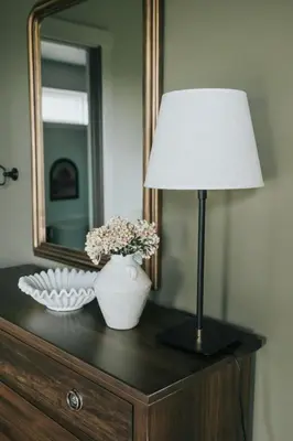 a lamp on top of a dresser with a mirror at Luxury Cabin at Beaver Creek with hot tub and stunning views in Strasburg