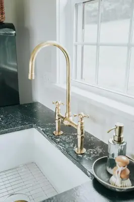 a kitchen counter with a sink and two faucets at Luxury Cabin at Beaver Creek with hot tub and stunning views in Strasburg
