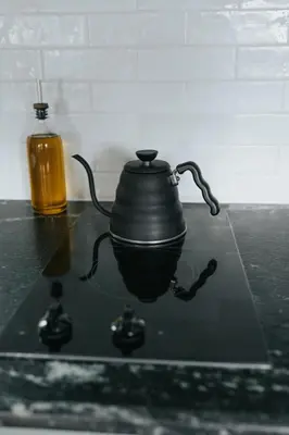 a tea pot sitting on a stove with a bottle at Luxury Cabin getaway with hot tub and stunning views in Strasburg