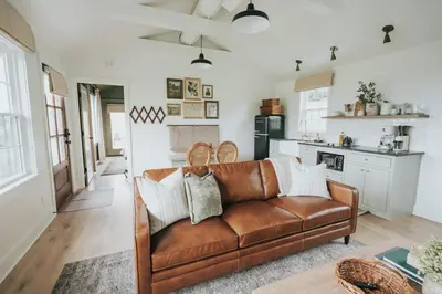 a living room with a brown leather couch at Luxury Cabin getaway with hot tub and stunning views in Strasburg
