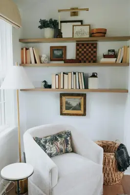 a living room with a white chair and shelves with books at Luxury Cabin getaway with hot tub and stunning views in Strasburg