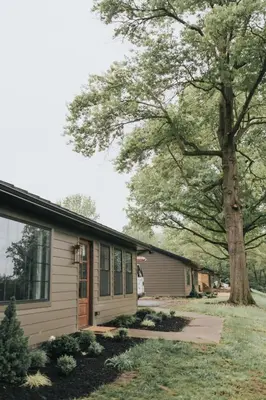 a house with a tree in front of it at Luxury Cabin getaway with hot tub and stunning views in Strasburg