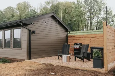 a garage with two chairs and a grill at Luxury Cabin at Beaver Creek with hot tub and stunning views in Strasburg