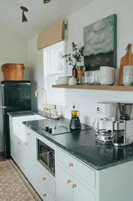 a kitchen with white cabinets and a black counter top at Luxury Cabin at Beaver Creek with hot tub and stunning views in Strasburg