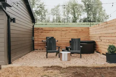 two chairs and a table in a backyard at Luxury Cabin at Beaver Creek with hot tub and stunning views in Strasburg