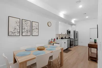 a kitchen and dining room with a table and chairs at Luxury Duplex in Hoboken 15Min to NYC, Fire Pit in Jersey City