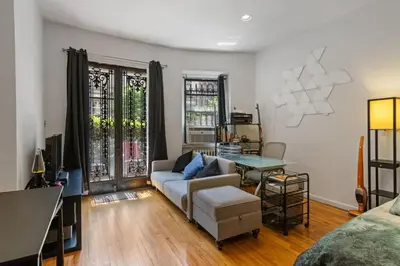 a living room with a couch and a table at Stylish Studio in Central Park Best Location Ever in New York