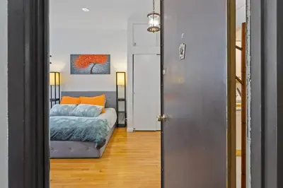 a bedroom with a bed and a painting on the wall at Stylish Studio in Central Park Best Location Ever in New York