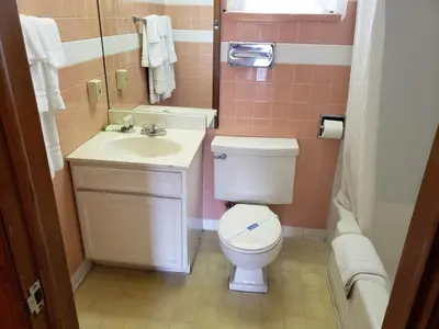 a bathroom with a toilet and a sink at Mansfield Inn in Mansfield