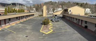 a parking lot with a car parked in it at Mansfield Inn in Mansfield