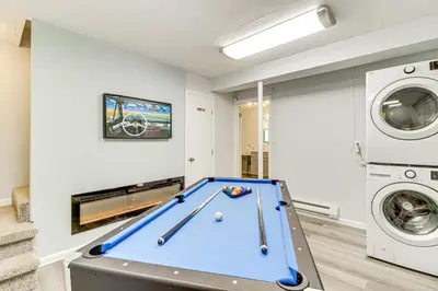 a living room with a pool table and a washer and dryer at Poconos Family Home with Lake Access and Game Room in Tobyhanna
