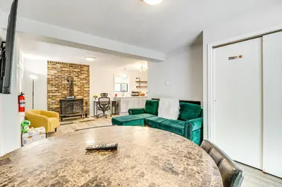 a living room with a table and a couch at Poconos Family Home with Lake Access and Game Room in Tobyhanna