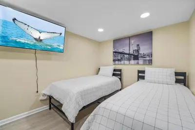 a bedroom with two beds and a picture of a whale at Free Parking -NEW 3BR-2Bath, 5 Beds, 10 Min to NYC, Sleeps 7 in Hoboken