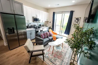 a living room with a couch and a kitchen at 1Bed&1Bath KingBed,WIFI,WD,Central in Philadelphia