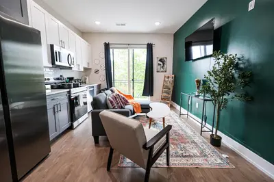 a kitchen and living room with a couch and a table at 1Bed&1Bath KingBed,WIFI,WD,Central in Philadelphia