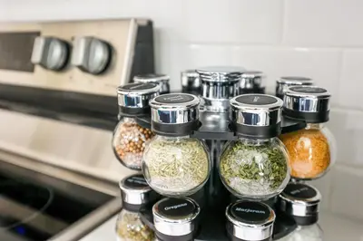 a group of glass jars filled with spices next to an oven at 1Bed&1Bath KingBed,WIFI,WD,Central in Philadelphia