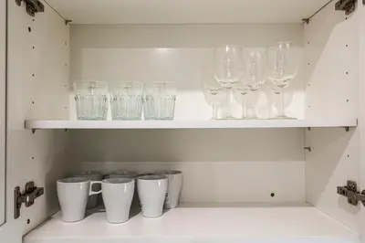 a row of wine glasses sitting on a shelf at 1Bed&1Bath KingBed,WIFI,WD,Central in Philadelphia