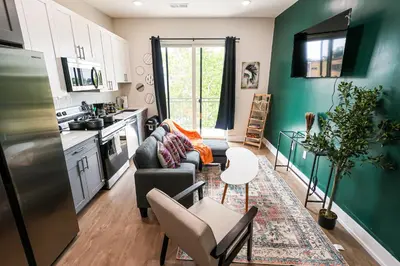a kitchen and living room with a couch and a table at 1Bed&1Bath KingBed,WIFI,WD,Central in Philadelphia