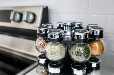 a group of glass jars filled with spices next to an oven at 1Bed&1Bath KingBed,WIFI,WD,Central in Philadelphia