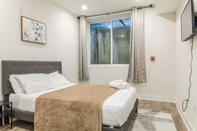 a bedroom with a bed and a window at 4Bedrm,4Bath-BackyardWiFi WDCoffeeParking in Philadelphia