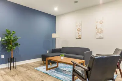a living room with a couch and a table at 4Bedrm,4Bath-BackyardWiFi WDCoffeeParking in Philadelphia