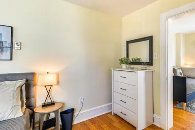 a bedroom with a bed and a dresser with a mirror at Near Nockamixon State Park Telford Apt with Porch! in Telford