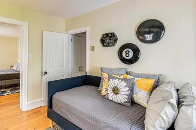 a couch in a living room with plates on the wall at Near Nockamixon State Park Telford Apt with Porch! in Telford