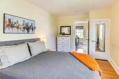 a bedroom with a bed with an orange blanket on it at Near Nockamixon State Park Telford Apt with Porch! in Telford