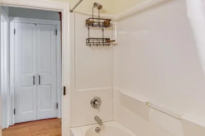 a white bathroom with a shower and a sink at Near Nockamixon State Park Telford Apt with Porch! in Telford