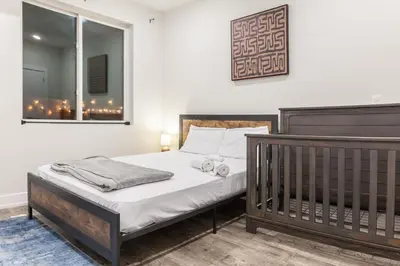 a bedroom with a bed with two towels on it at 4BR4Bath Home WiFi WD Ping Pong in Philadelphia