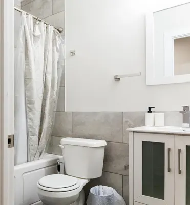 a white bathroom with a toilet and a sink at 4BR4Bath Home WiFi WD Ping Pong in Philadelphia