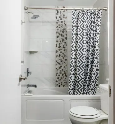 a bathroom with a tub and a toilet and a shower at 4BR4Bath Home WiFi WD Ping Pong in Philadelphia