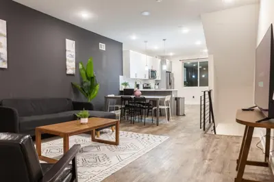 a living room with a couch and a table at 4BR4Bath Home WiFi WD Ping Pong in Philadelphia