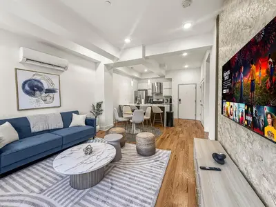 a living room with a blue couch and a table at Apartmint at Liberty B - Philadelphia in Philadelphia