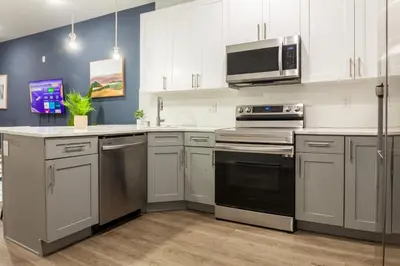 a kitchen with white cabinets and stainless steel appliances at 2BR2BA ApartmentWDWiFi Near Temple in Philadelphia