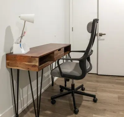 a desk with a chair and a lamp on it at 2BR2BA ApartmentWDWiFi Near Temple in Philadelphia